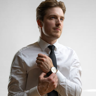 Man wearing black and white THT watch.